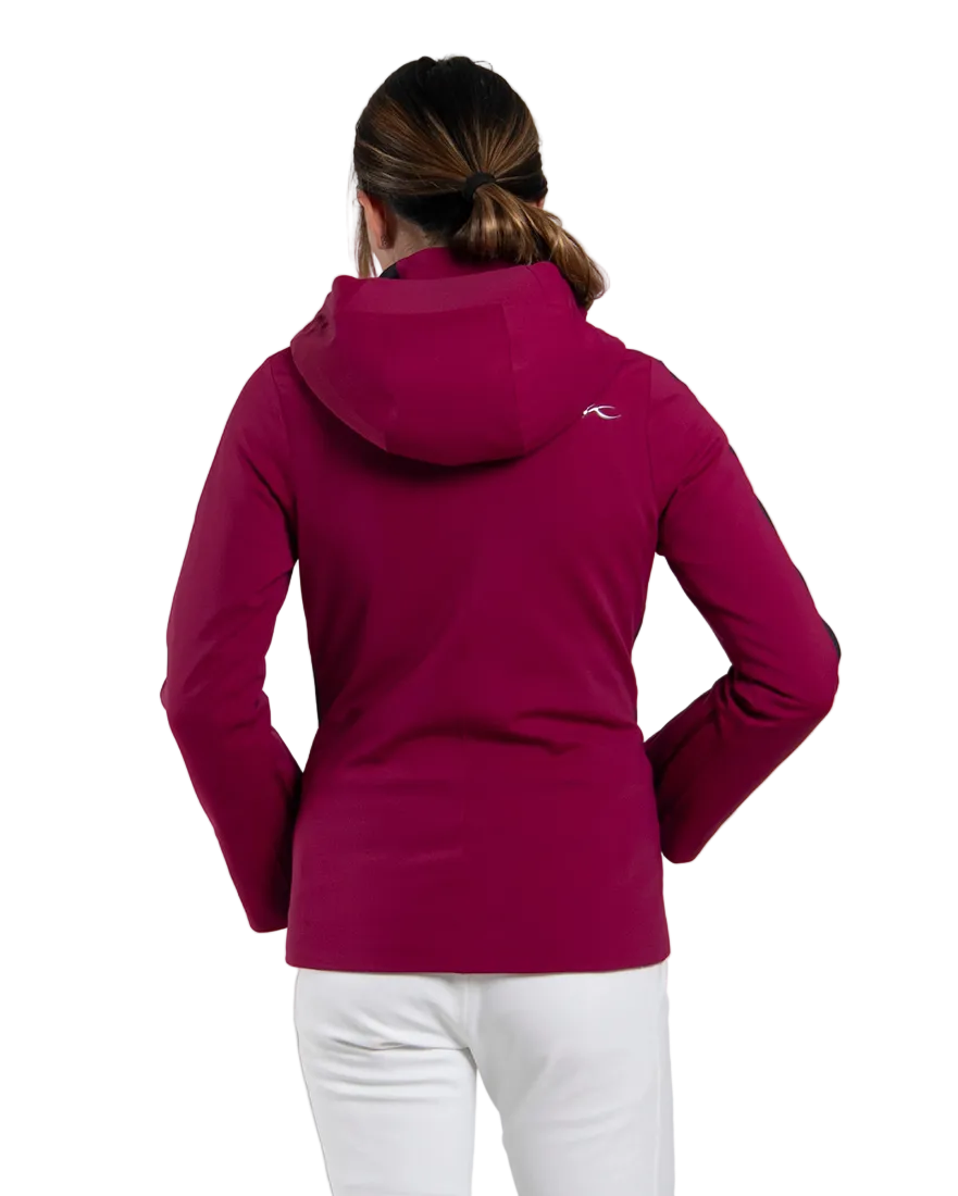 Rear view of a velvet rouge/black Kjus Women’s Formula Jacket featuring 4-way stretch waterproof fabric, Fast Thermo Core insulation, water-repellent zippers, AC-Vent forearm ports, and a detachable helmet-compatible hood.