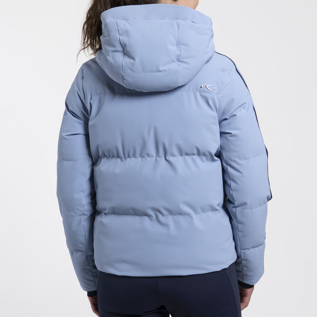 KJUS Women's Twilight Ski Jacket featuring waterproof construction, lightweight insulation, four-way stretch fabric, adjustable hood, and premium alpine performance.