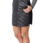 Front view of a black Krimson Klover Women’s Carving Skirt featuring a quilted 120g insulated core, stretch side panels, side zipper entry, and a comfortable elastic waistband.