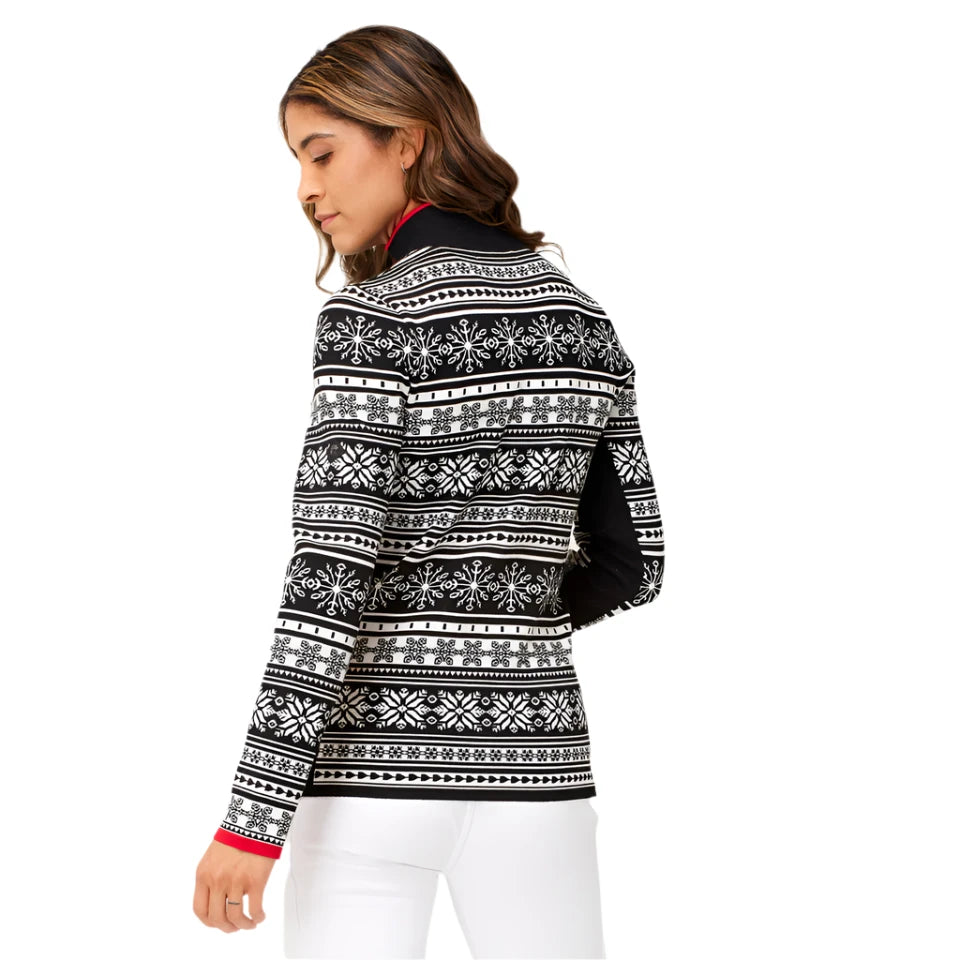 A woman wearing a black and white Krimson Klover Women's Holiday Cardigan Snow that features 4-way stretch, a brethable knit, and a geometric snowflake pattern.