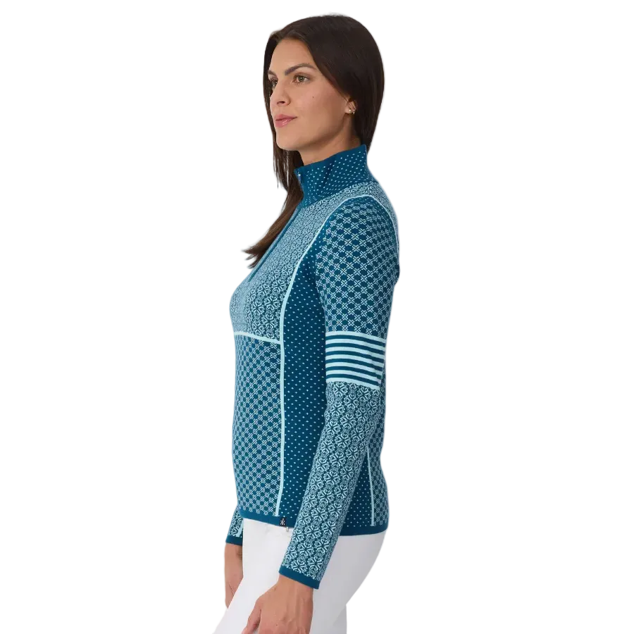Side view of a teal Krimson Klover Women’s Pow 1/2 Zip Sweater featuring a mid-weight technical stretch knit, deep half-zip front zipper with chin guard, flatlock seams, and graphic print.