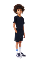Lacoste Boys Sport Diamond Weave Shorts featuring lightweight breathable fabric, athletic fit, elastic waistband, and crocodile branding.