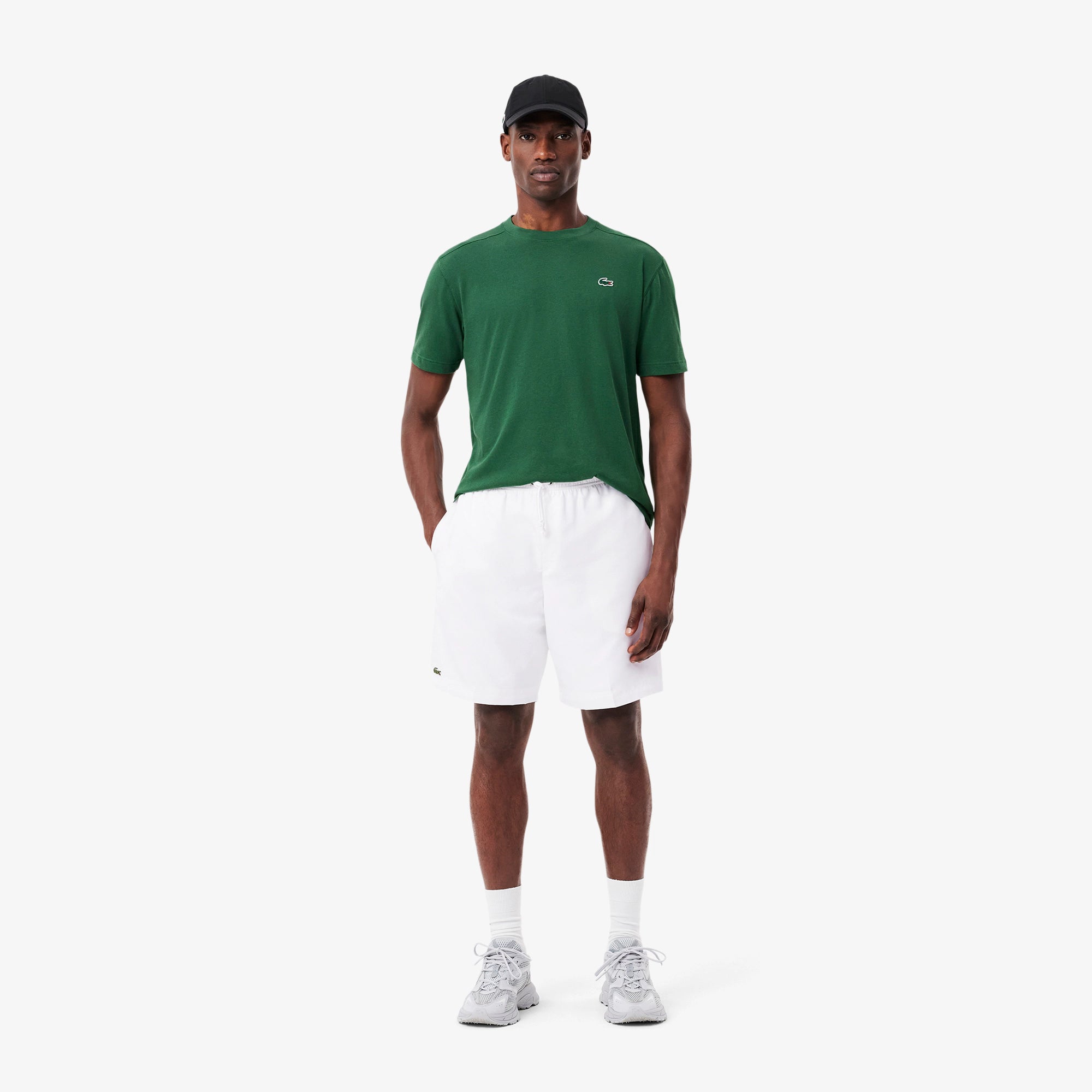 Lacoste Men's Lightweight Tennis Shorts featuring breathable performance fabric, side pockets, athletic fit, and crocodile branding.