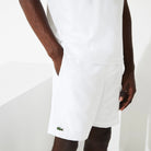 Lacoste Men's Lightweight Tennis Shorts featuring breathable performance fabric, side pockets, athletic fit, and crocodile branding.