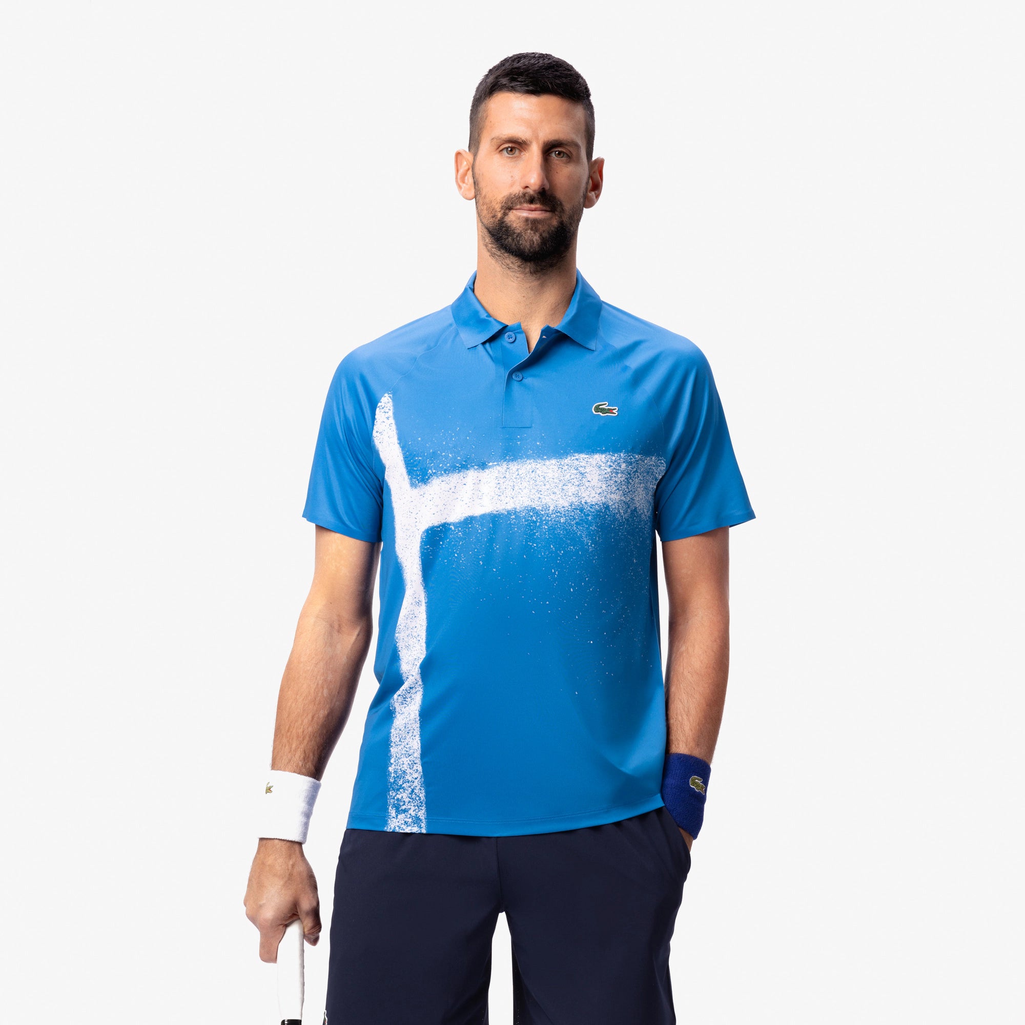 Lacoste Men's Tennis x Novak Djokovic On-Court Polo featuring breathable performance fabric, athletic fit, and signature collection detailing.