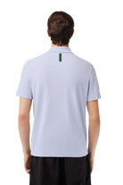 Lacoste Men's Ultralight Piqué Movement Polo featuring lightweight breathable fabric, stretch comfort, and signature crocodile branding.