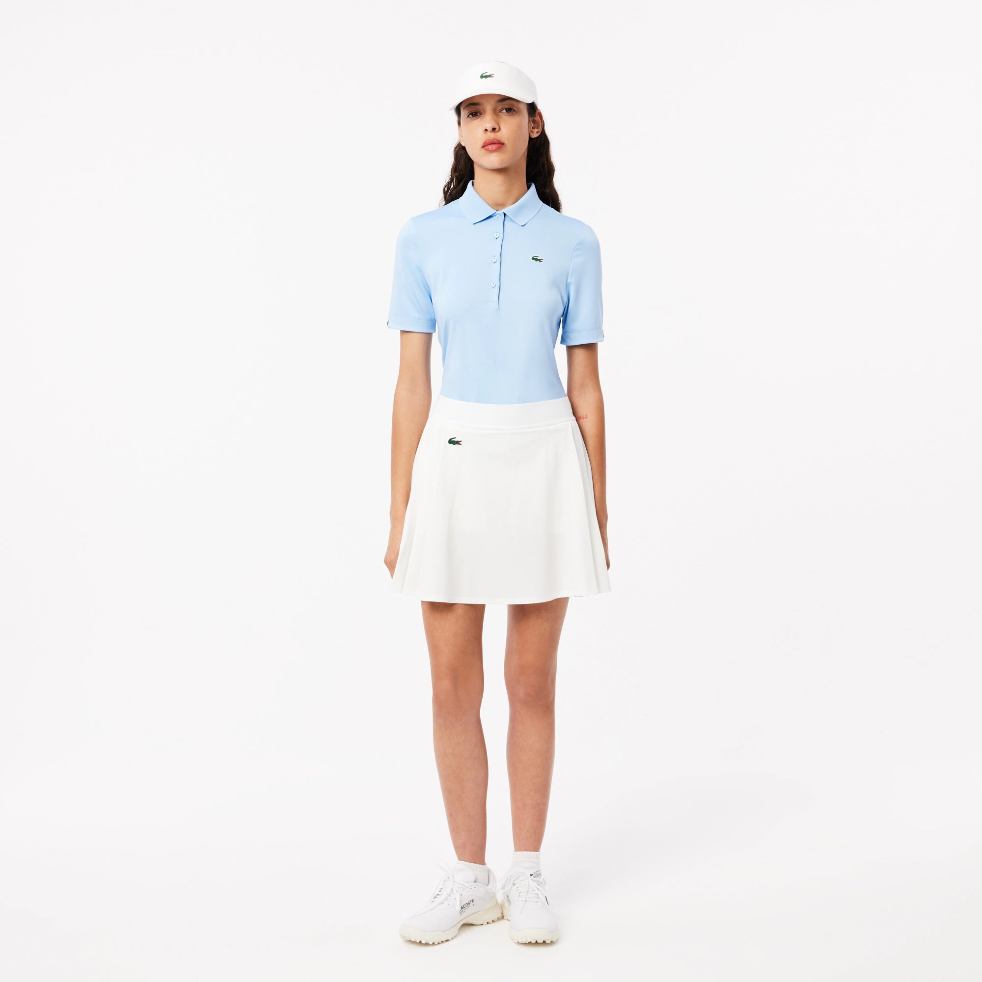 Lacoste Women's Ultra Dry Lined golf skirt with built-in shorts, stretch performance fabric, and moisture-management technology for golf wear