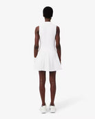 Lacoste Women's Ultra Dry Stretch Tennis Dress featuring moisture-wicking stretch fabric, breathable comfort, athletic fit, and crocodile branding.