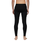 A man wearing a pair of Le Bent Men's Core Midweight Baselayer Bottoms that are made with a bamboo and merino wool blend.