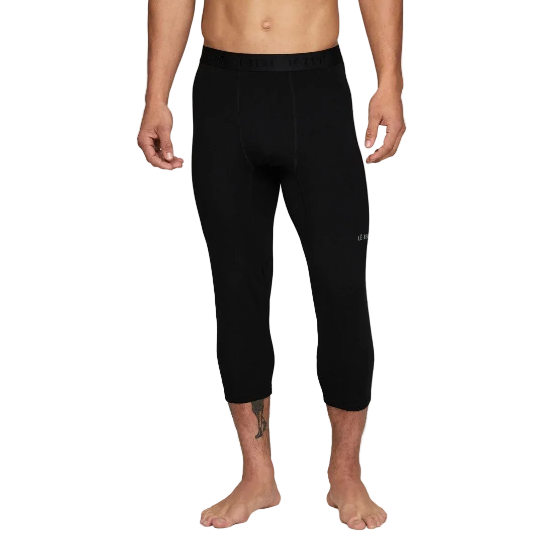 A pair of black Le Bent Men's Core Midweight 3/4 Baselayer Bottoms that are made from a bamboo and merino wool blend.