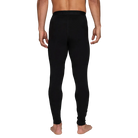 A man wearing a pair of Le Bent Men's Core Midweight Baselayer Bottoms that are made with a bamboo and merino wool blend.