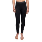 A woman wearing a pair of black 200g Le Bent Women's Core Lightweight Baselayer Bottoms which are designed to keep you warm in harsh winter conditions.