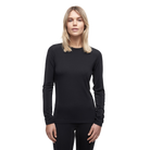 A woman wearing a black Le Bent Women's Core Lightweight Crewneck Baselayer Top that is made from a merino wool and bamboo blend.