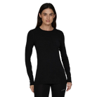 A woman wearing a black Le Bent Women's Core Midweight Crewneck Baselayer Top that is made from a bamboo and merino wool blend.