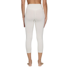 A pair of white Le Bent Women's Core Midweight 3/4 Length Baselayer Bottoms that are made from a bamboo and merino wool blend.