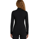 Rear view of the Le Bent Women’s Midweight Mock Neck Baselayer Top featuring a bamboo-merino blend knit, fitted mock neck collar, flatlock stitching, and integrated thumb loops.