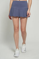 Lija Elite Dash Women's Tennis Skort featuring lightweight stretch performance fabric, built-in shorts, moisture-wicking comfort, and athletic styling.