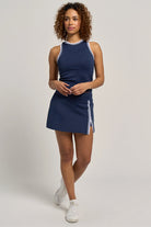 Lija Sportif Uprise 13" Tennis Skort featuring stretch performance fabric, built-in shorts, moisture-wicking comfort, and athletic styling.
