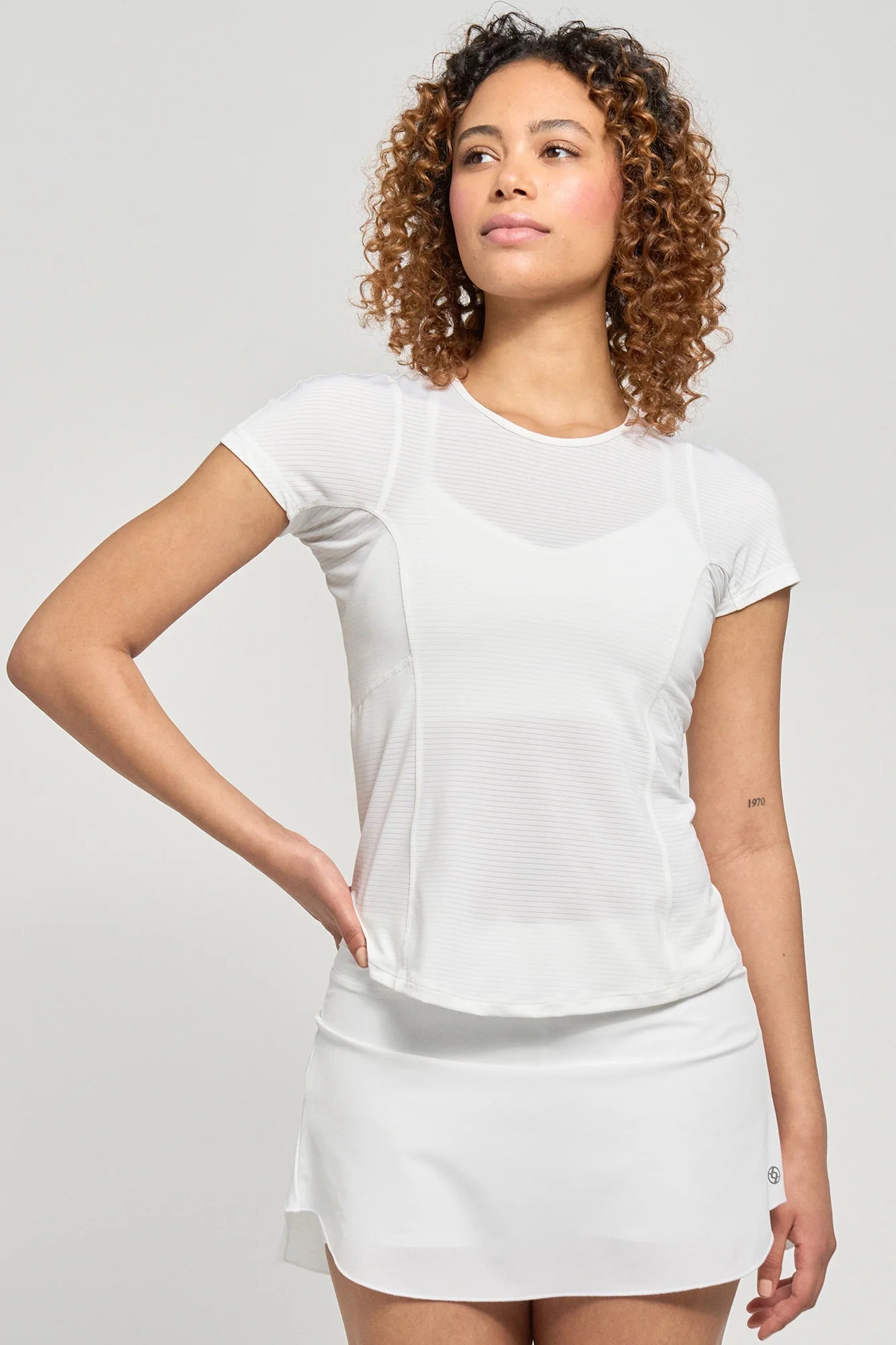 Lija Women's New Stripe Fluid Tennis Tee featuring lightweight performance fabric, moisture-wicking comfort, breathable construction, and modern striped styling.