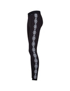 A pair of black Newland Women's Croix de Couer Leggings that feature a white snowflake pattern down the legs and are moisture-wicking, breathable, and stretchable.