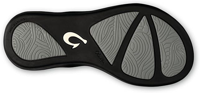 A silver Olukai Junior Girls Ho'opio flip-flop sandal with a grey sole on a white background