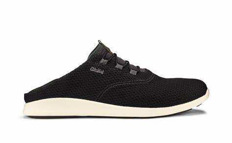 A black Olukai Mens 'Alapa Li Shoe highlighting the collapsible heel on a white background