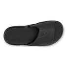 Black Olukai Men's Nalu Slide sandal with a strap on a white background