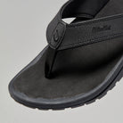 Black Olukai Men's Ohana flip-flop sandal with an Olukai logo on a white background