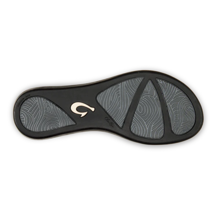 A black Olukai Women's Ho'opio flip-flop sandal on a white background