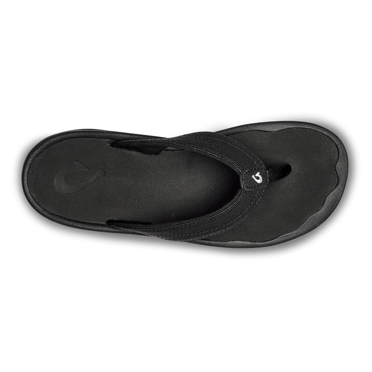 A black Olukai Women's Ohana flip-flop sandal on a white background