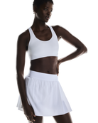 On Women's Court Pleated Skirt featuring lightweight performance fabric, pleated styling, built-in shorts, and athletic comfort.