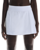 On Women's Court Pleated Skirt featuring lightweight performance fabric, pleated styling, built-in shorts, and athletic comfort.