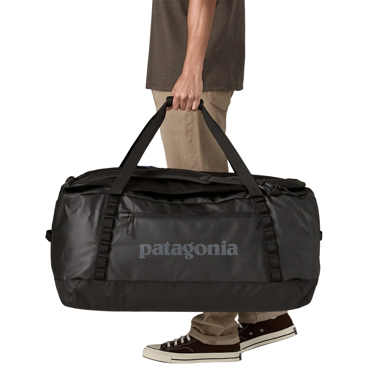 Front view of the black on black Patagonia Black Hole Duffel 100L featuring weather-resistant TPU-laminated ripstop fabric, removable ergonomic backpack shoulder straps, reinforced end haul handles, a padded base, and heavy-duty exterior daisy chain lash loops.