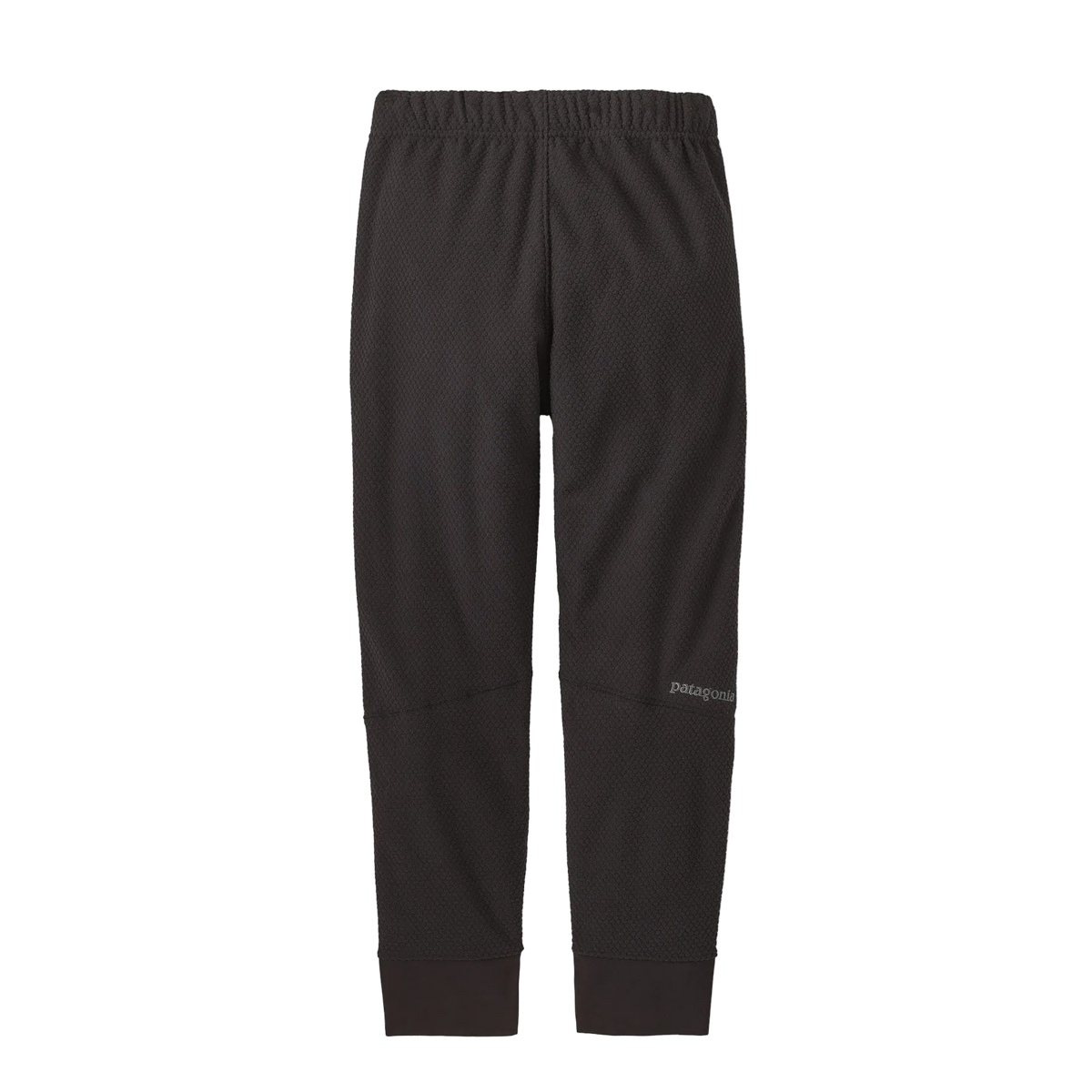 Rear view of the black Patagonia Junior Midweight Layering Pants featuring 100% recycled pebbled-texture fleece fabric, a flat elastic waistband, a gusseted crotch, and flatlock seam construction.