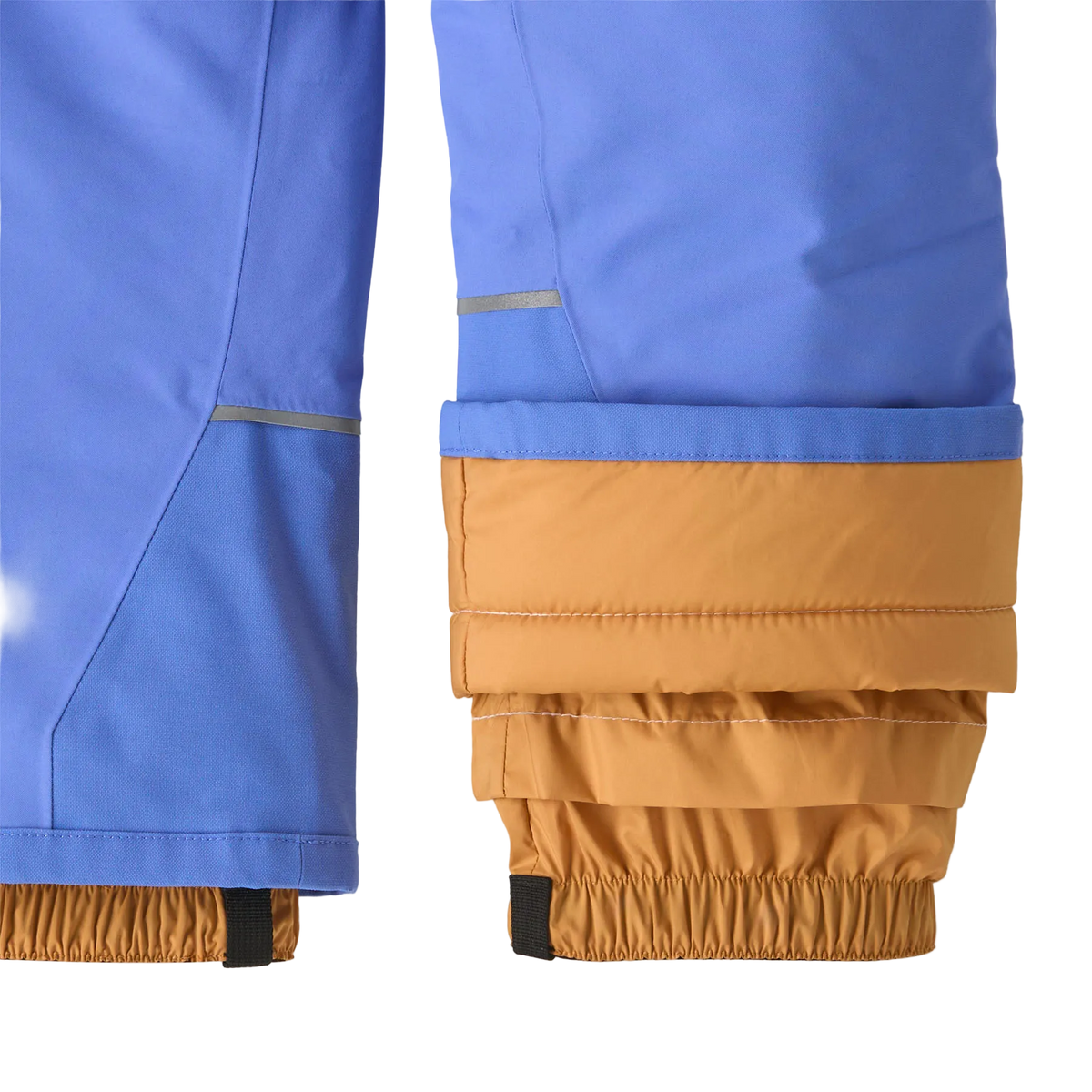 A close up of the diver blue Patagonia Junior Snow Pile Bib Pants featuring a 2-layer H2No Performance Standard shell, 100g Thermogreen 100% recycled polyester insulation, high-coverage bib torso with adjustable elastic shoulder straps, full-length center-front zipper with dual storm flaps, articulated knees, heavy-duty ankle scuff guards, internal boot gaiters with gripper elastic, and Grow-Fit extendable leg cuffs.