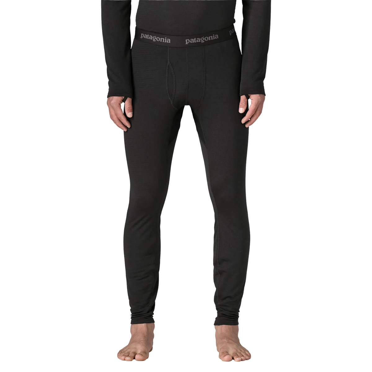 Front view of the black Patagonia Men's Capilene Thermal Weight Baselayer Bottoms featuring Polartec Power Grid fabric with an open-grid brushed interior, a flat elastic waistband, a functional fly, a gusseted crotch, and flatlock seam construction throughout the legs and cuffs.
