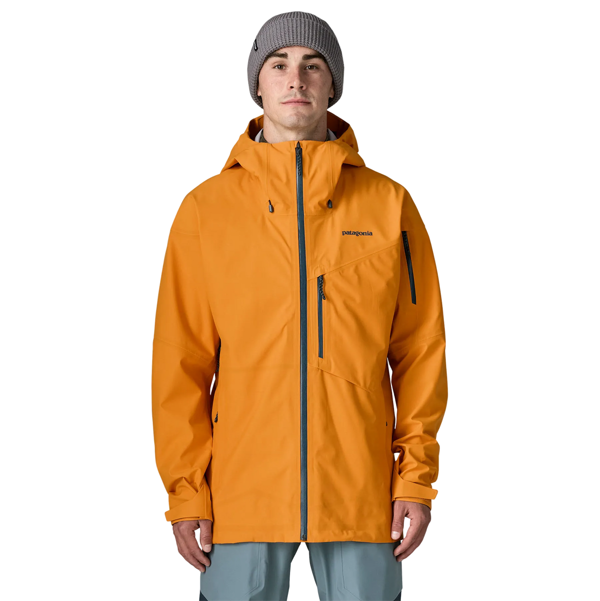 Front view of the Patagonia Men's SnowDrifter Jacket featuring a 3-layer H2No Performance Standard waterproof stretch shell fabric, a soft knit backer, a two-way adjustable helmet-compatible hood with laminated visor, a watertight full-length center-front zipper, pit zips for underarm ventilation, dual zippered chest pockets, dual zippered handwarmer pockets, an arm pass pocket, adjustable hook-and-loop cuffs, an adjustable powder skirt, and an embedded RECCO reflector.