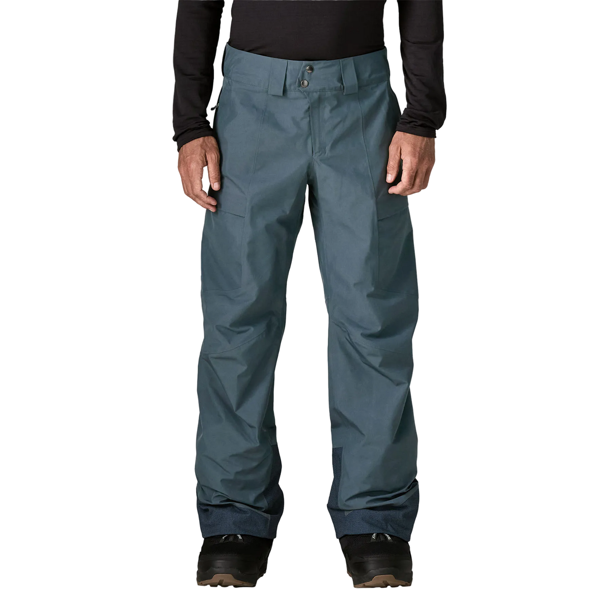 Front view of the Patagonia Men's Storm Shift Pants featuring a 2-layer GORE-TEX shell made from 100% recycled polyester, a body-mapped zig-zag fleece and mesh lining, outer thigh ventilation zips with mesh backing, adjustable waist tabs with belt loops, dual zippered thigh pockets, scuff guards at the inner ankles, internal gaiters with gripper elastic, and an embedded RECCO reflector.