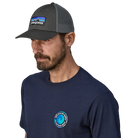 Front view of a forge grey Patagonia P-6 Logo LoPro Trucker Hat featuring an organic cotton canvas front crown, embroidered original artwork, NetPlus precurved brim, recycled polyester mesh back, and an adjustable rear snap closure.
