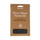 Patagonia Patch Kit shown with four sheets of black, pressure-sensitive Tenacious Tape adhesive repair patches in various pre-cut and customizable shapes.