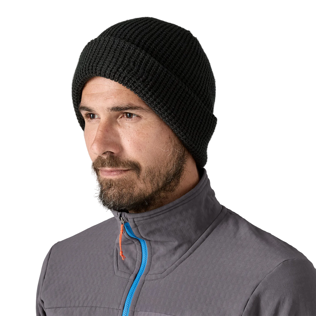 Front view of a black Patagonia SnowDrifter Beanie featuring a fine-gauge recycled polyester knit, low-profile helmet-compatible crown, and an interior microfleece headband lining.