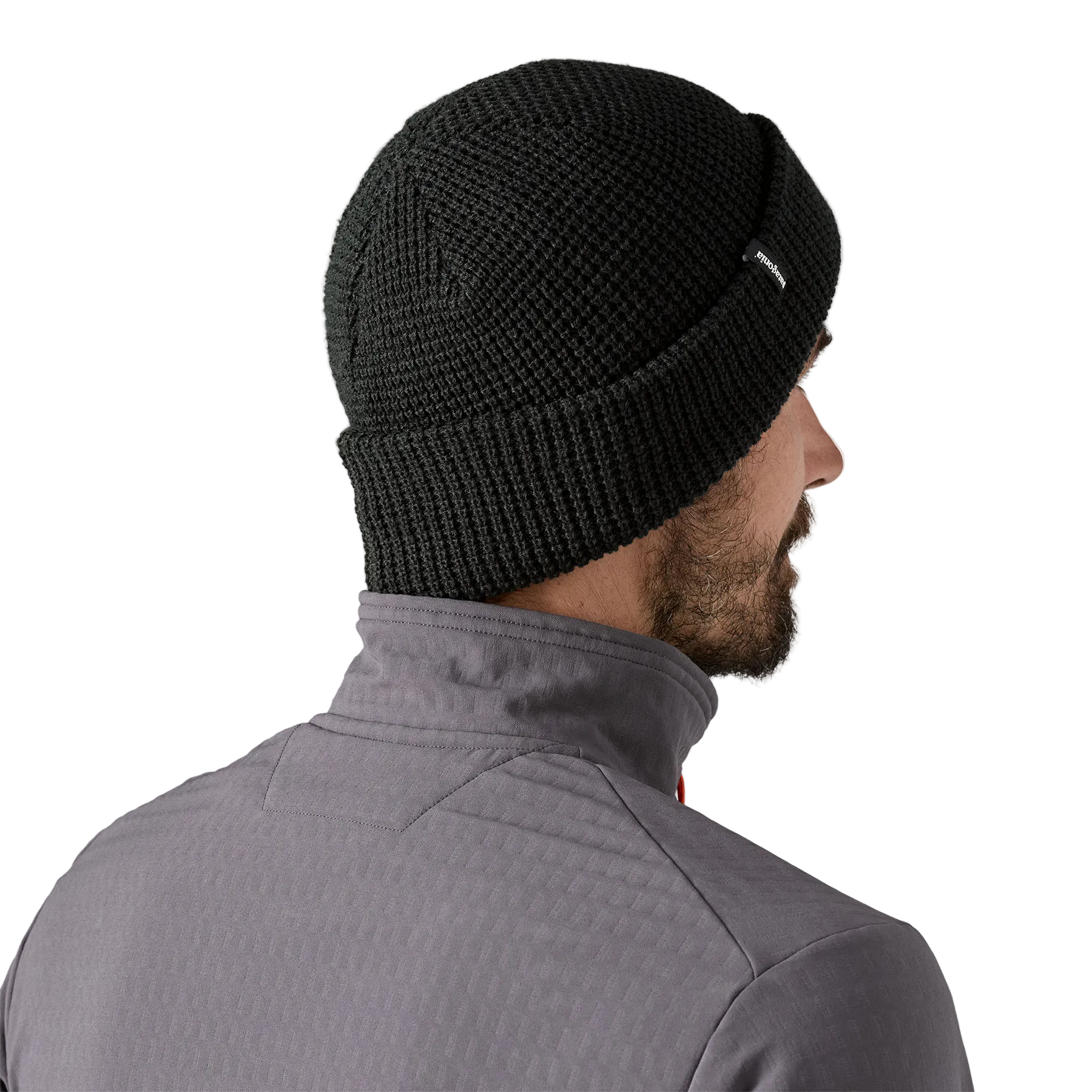 Rear view of a black Patagonia SnowDrifter Beanie featuring a fine-gauge recycled polyester knit, low-profile helmet-compatible crown, and an interior microfleece headband lining.