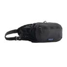 Front view of a black Patagonia Terravia Hip Pack featuring recycled nylon ripstop fabric, dual stretch-mesh water-bottle pockets, zippered main and front stash pockets, an airmesh back panel, and an adjustable webbed waist strap.