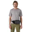 Front view of a black Patagonia Terravia Hip Pack featuring recycled nylon ripstop fabric, dual stretch-mesh water-bottle pockets, zippered main and front stash pockets, an airmesh back panel, and an adjustable webbed waist strap.