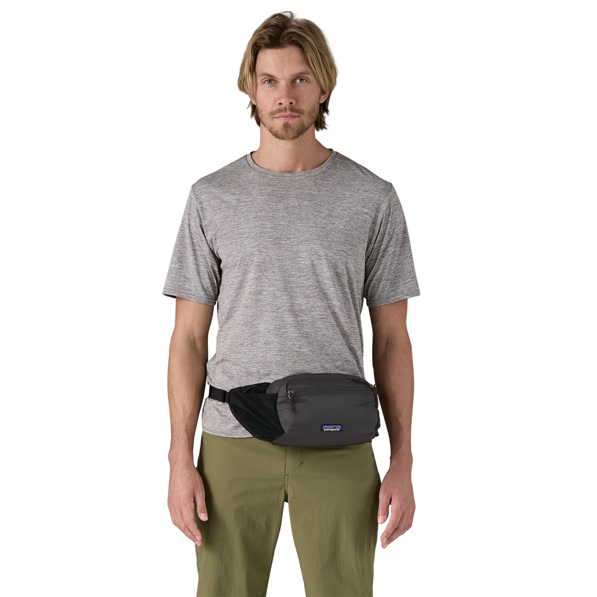 Front view of a black Patagonia Terravia Hip Pack featuring recycled nylon ripstop fabric, dual stretch-mesh water-bottle pockets, zippered main and front stash pockets, an airmesh back panel, and an adjustable webbed waist strap.