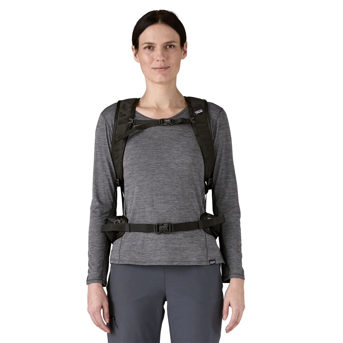 Front view of a black Patagonia Terravia Pack 22L featuring 100% recycled nylon ripstop fabric, breathable Regulator airmesh shoulder straps, a front quick-stash pocket, dual side stretch water-bottle pockets, and trekking pole attachment loops.
