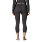 Rear view of the black Patagonia Women's Capilene Thermal Weight Boot Length Baselayer Bottoms featuring a 3/4 boot-length hem, Polartec Power Grid fabric with an open-grid brushed interior, a flat elastic waistband, a gusseted crotch, and flatlock seam construction.