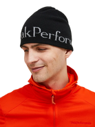 Front view of the Peak Performance Logo Hat featuring a soft double-layer knitted construction, fold-up cuff, stretch fit, and an embroidered front logo.