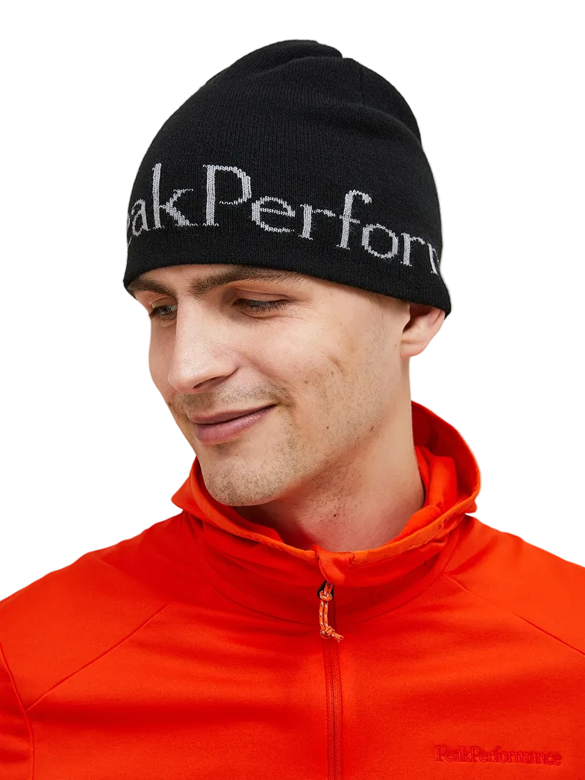 Front view of the Peak Performance Logo Hat featuring a soft double-layer knitted construction, fold-up cuff, stretch fit, and an embroidered front logo.
