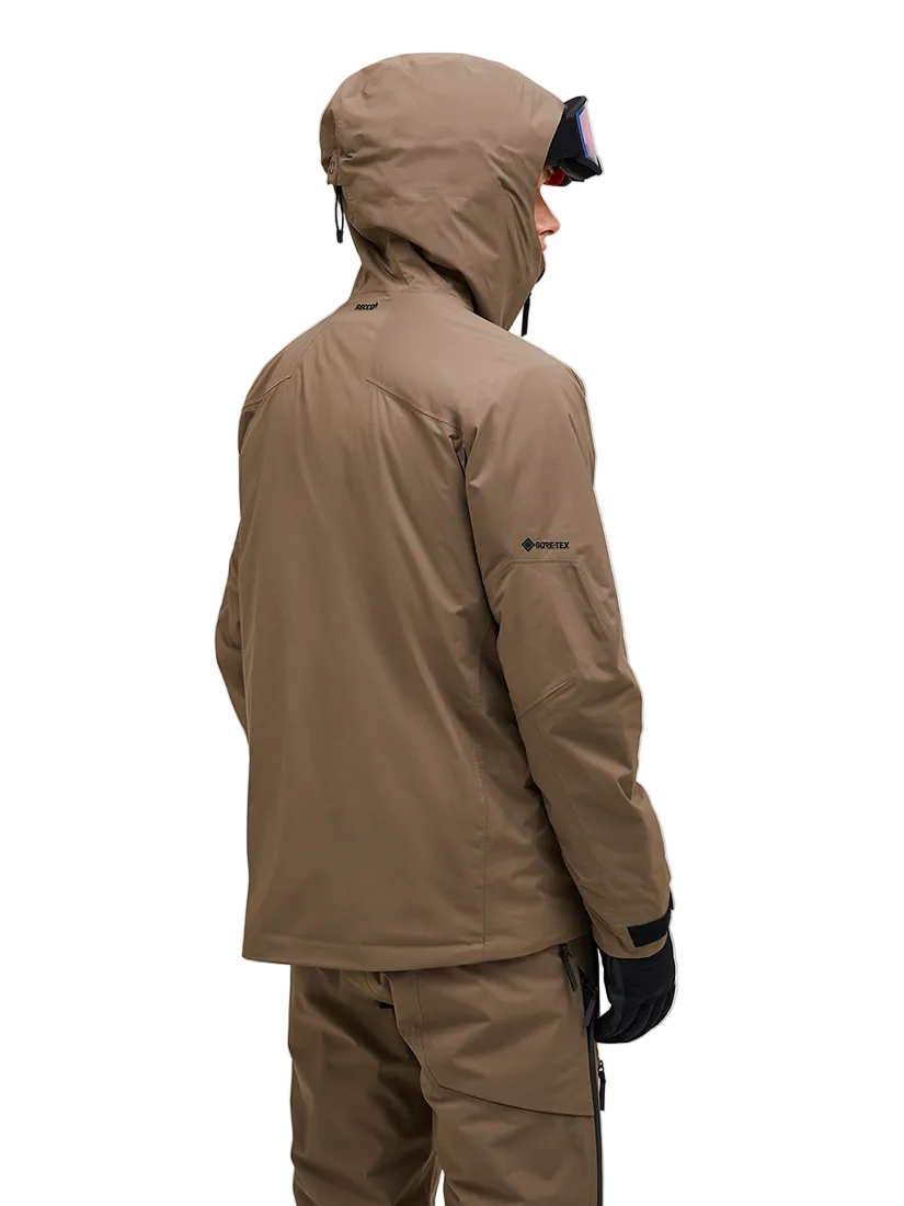 Rear view of a tan Peak Performance Men's Alpine GORE-TEX 2L Insulated Shell Jacket featuring a 2-layer GORE-TEX waterproof membrane, YKK AquaGuard storm zippers, a radio pocket, and a helmet-compatible hood.
